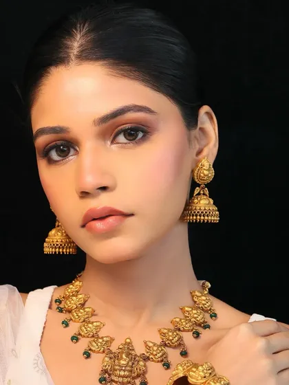A closer look at a soft glam look for a traditional jewelry shoot. The focus here is on creating a clean canvas with sculpted, defined features and radiant skin, allowing the intricate gold jewelry to be the star of the show.