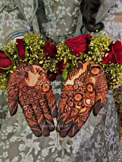 The beautiful henna stain on an engagement look, adorned with floral jewelry.