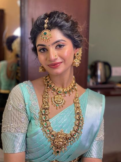 Draping for Swathi Naidu in a beautiful pastel blue saree. This look is perfect for a special occasion or function, with a soft drape that complements her elegant jewellery.