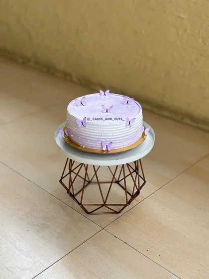 A simple purple butterfly cake with delicate, edible butterflies.