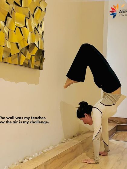 Find your strength and challenge your limits. This powerful image of a yogi mastering a handstand captures the spirit of growth and balance that we encourage in our wellness community.