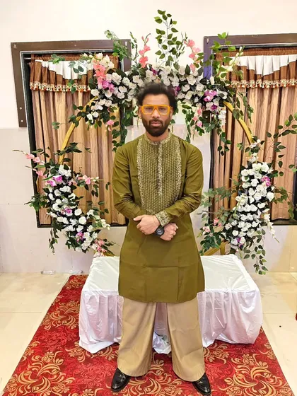 I design some of my own clothes now. Showing off a custom-made olive green kurta.