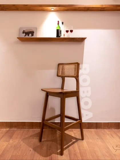 The 'Rooba' bar stool, the perfect chair for your breakfast counter or home bar. It features a solid teak frame and a comfortable rattan backrest.