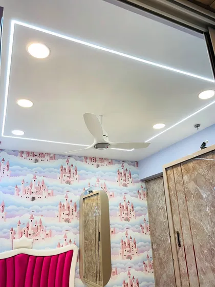 A look at the false ceiling in the kids' bedroom, featuring clean rectangular cove lighting and spotlights. This provides both ambient and focused light for the room.