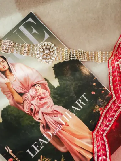 An artistic flat-lay of the bride's jewellery on a Vogue magazine. This shot combines high fashion with wedding details, reflecting a modern bride's style.