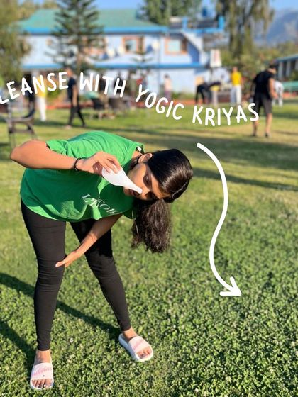 A student practices the yogic cleansing kriya of Jal Neti outdoors. This practice helps clear the nasal passages and is especially beneficial in the fresh mountain air.