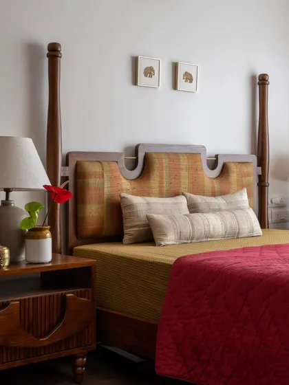 The Thiranottam Bed, designed for the Layam residence, is a direct tribute to the Kathakali art form. The headboard's shape and fabric are inspired by the 'Thiranottam', a moment where the artist peeks over the curtain before a performance, bringing a piece of theatrical heritage into the bedroom.
