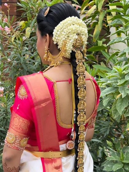 A close-up of the beautiful 'Jade Bangara' hair ornament, intricately designed with temple motifs to match the main jewellery set. We rent these out to complete your bridal look.