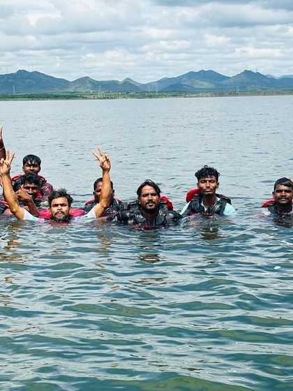 A group of swimmers enjoys the open water at Vani Vilas Sagar, a fun and safe activity supervised by our team.