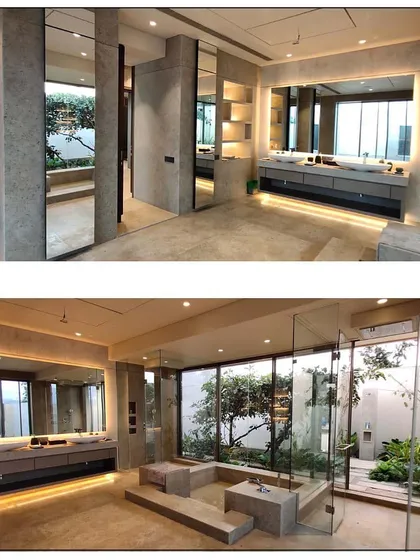 This bathroom blurs the line between indoors and outdoors, creating a private spa experience. The design incorporates a sunken jacuzzi, dual vanities, and a glass wall that opens to a secluded garden, allowing our client to connect with nature while enjoying modern comforts.