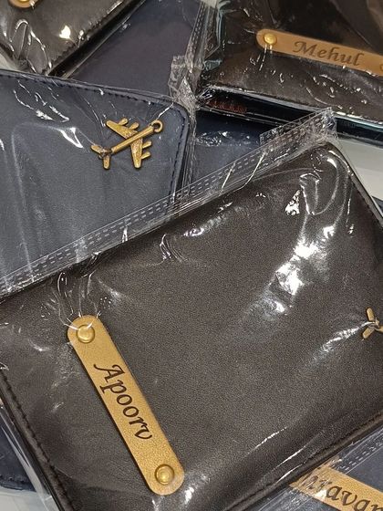 A collection of customized passport covers in premium leatherette, each with a nameplate and a charm. A perfect personalized gift for travelers.