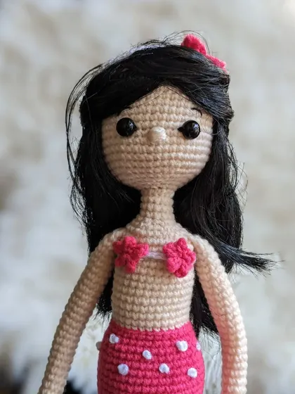 A close-up of the mermaid doll's face and hair.