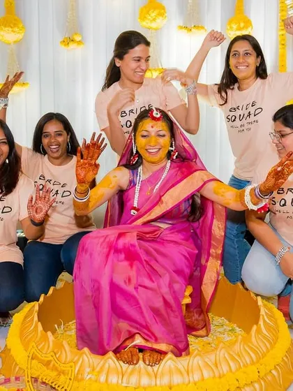 The bride poses with her "Bride Squad" during the haldi, a fun and memorable shot with her closest friends.