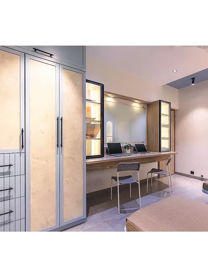 This view shows the full length of the room, highlighting the smart space planning that accommodates two beds, a large wardrobe, and a double study station without feeling cramped.
