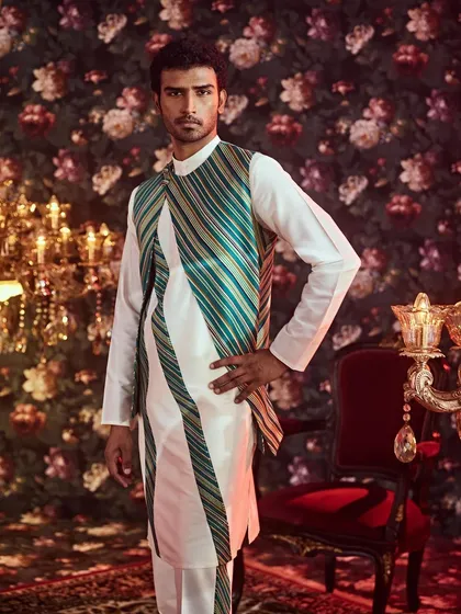Our fusion wear collection blends tradition with contemporary design, as seen in this asymmetrical long jacket with striking slanted stripes for a modern silhouette.