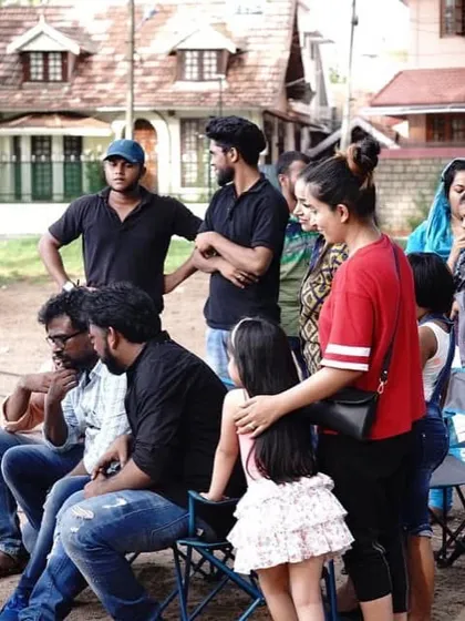 The whole crew gathered around the monitor to review a take. Teamwork is essential in filmmaking.