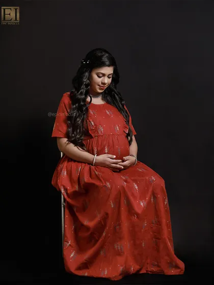 A full-length view of the casual red dress, showing a serene and contemplative pose.