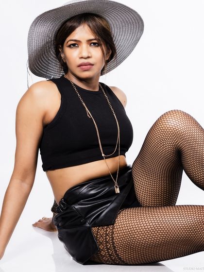 A seated pose with the hat, for a relaxed yet stylish look.