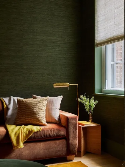 The Gold Coast Silk collection from Phillip Jeffries envelops this cozy room in a deep, rich green. The natural texture of the silk adds a layer of understated luxury and warmth.