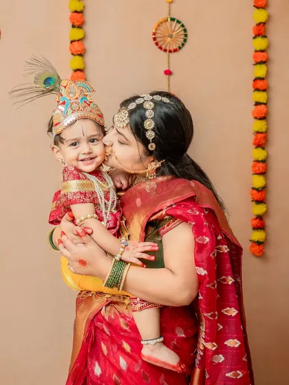 A mother's tender kiss for her little Krishna. These moments are priceless and add a deep emotional layer to the photoshoot.