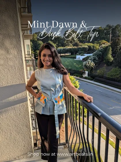 A client wearing the Mint Dawn & Dusk Belt Top. This photo shows how the art-infused belt adds a unique and stylish touch to a simple, elegant outfit.
