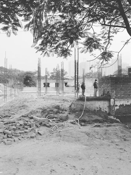 A site visit during the early stages of construction. Here, the foundation is being laid and the building's initial footprint is taking shape.