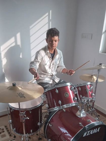 A drummer student practicing in our well-lit and comfortable practice room.