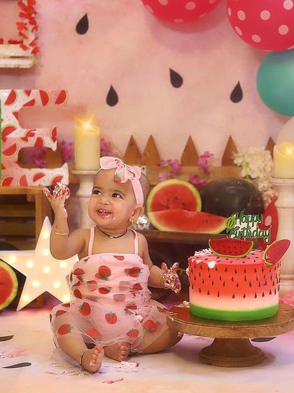 Getting delightfully messy with her watermelon cake! These are the moments I love to capture during a first birthday cake smash photoshoot.