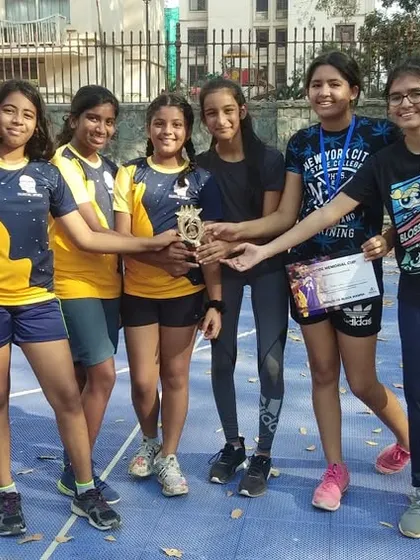 A casual moment with one of our girls' teams and their trophy. We believe that consistency beats intensity, and these players show up for each other every time.