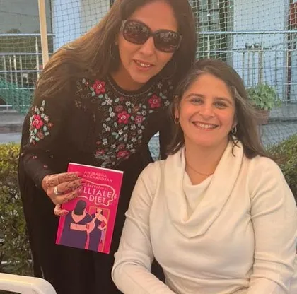 A member proudly holds her copy of "The Secret of a Telltale Diet" with author Anu Singh Choudhary. These personal interactions are a cherished part of our club's experience.