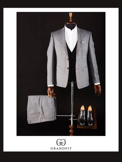 A grey plaid three-piece suit, displayed to show the complete ensemble including the trousers. This is a versatile option for both business and events.