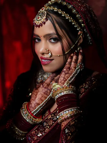 The beauty of a North Indian bride is in the details. I use dramatic lighting to highlight the intricate henna, the rich colors of the lehenga, and the bride's confident gaze, creating a powerful and artistic bridal portrait.