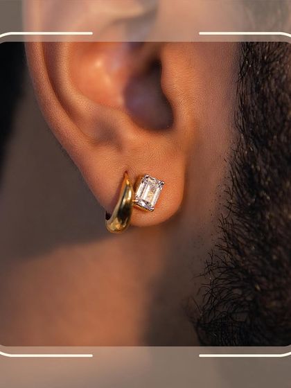 A subtle statement of style. This close-up features our modern men's diamond stud earring, a perfect blend of classic gold and a single brilliant stone for a touch of everyday luxury.