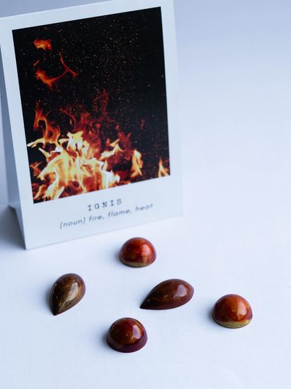 "Ignis" bonbons that look like fire. Students learn to blend colors to create a dynamic, flame-like effect on their chocolate shells.