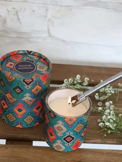 Our scented candle in a vibrant, patterned tin. Each candle is designed to be a whole mood, filling your space with warm fragrances that linger long after the flame is out.