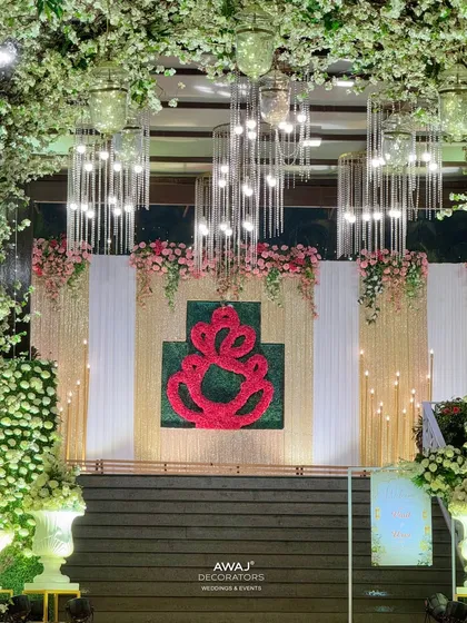 A stunning floral Ganesha backdrop at the end of a blossom-lined walkway, creating a divine welcome.
