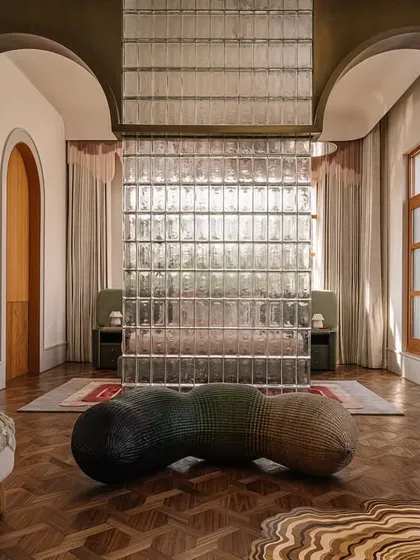 A collection of views from the Rehethaan project, showcasing the daughter's bedroom with its unique glass brick wall, the guest bedroom, and the master bedroom with its layered headboard design.