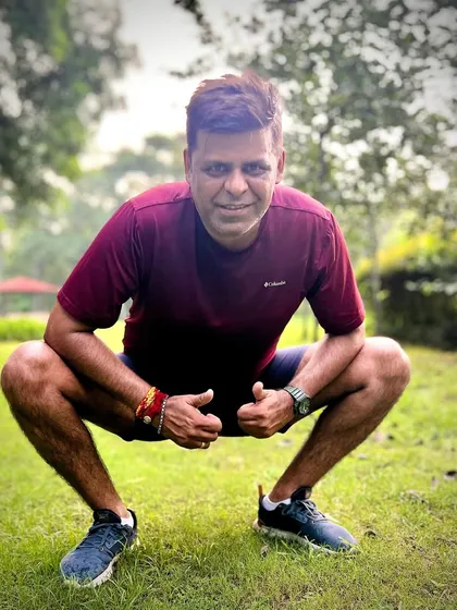 A member takes a moment for a cool-down squat after a solid run. We focus on the full fitness journey, including proper warm-ups and cool-downs.