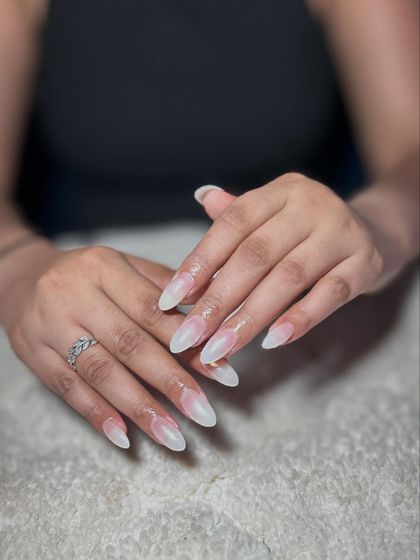 A beautiful set of pearly white or 'glazed donut' nails. This trendy, minimalist look requires a perfect application for that signature chrome glow.
