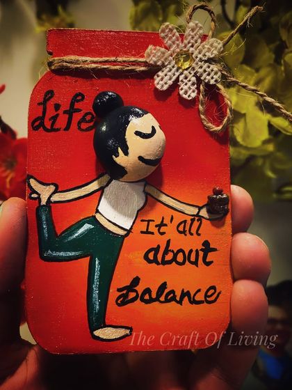 "It's all about balance." A cute, hand-painted wooden magnet featuring a yoga pose, perfect for celebrating International Yoga Day or for any yoga enthusiast.