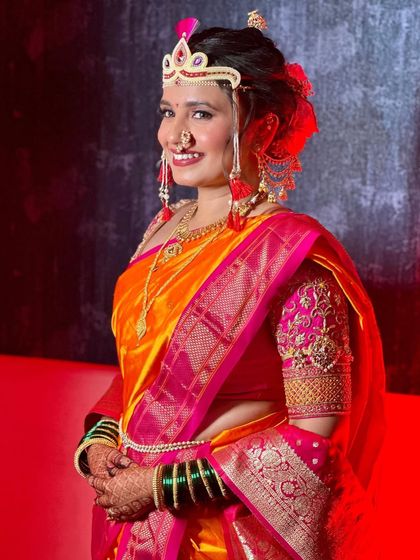 The bride glows in her complete Maharashtrian attire. The makeup is designed to highlight her features and complement the rich colors of her outfit.
