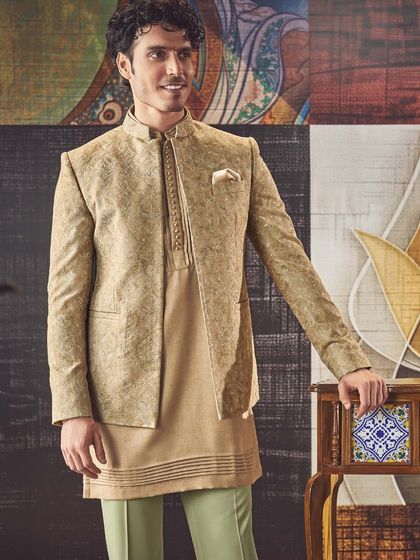 This earthy-toned kurta is layered with a matching patterned jacket. It is a sophisticated look that combines comfort with impeccable, timeless style.