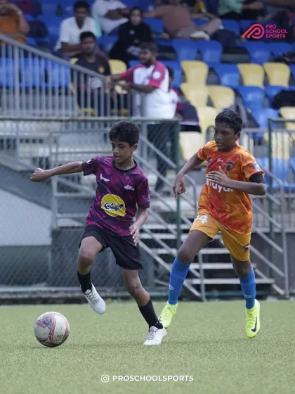 A dynamic action shot of a player dribbling past an opponent in a stadium.
