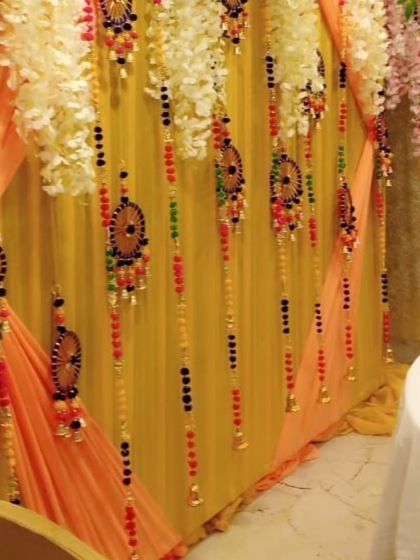 A close-up showing the details of my hanging decorations. These include colorful beads, small bells, and handcrafted ornaments that I use to adorn backdrops for a unique touch.