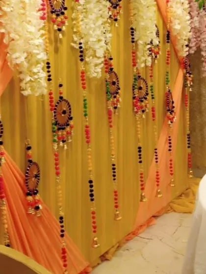 A close-up showing the details of my hanging decorations. These include colorful beads, small bells, and handcrafted ornaments that I use to adorn backdrops for a unique touch.
