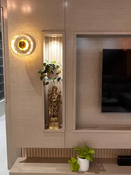A close-up of the TV unit niche, which provides a perfect spot for a small idol or decorative piece. The integrated lighting beautifully highlights the object on display.