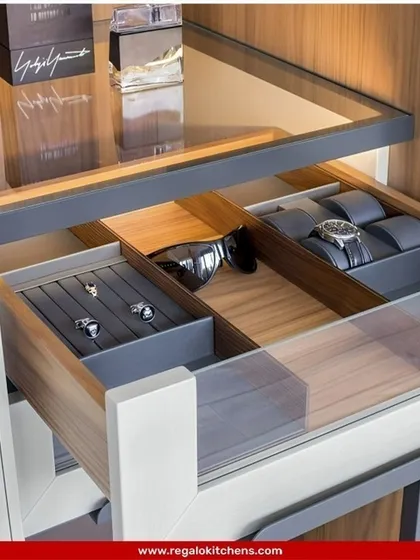A sleek, glass-topped drawer that displays your watches and accessories while keeping them dust-free. The internal compartments are tailored for specific items like cufflinks and sunglasses.