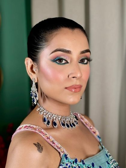 Another portrait from the colorful Mehendi shoot, showing how the makeup ties in with the intricate, multi-colored outfit.