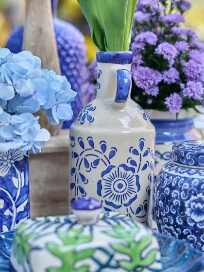A beautiful close-up of the blue and white themed tablescape, with hand-painted pottery and fresh hydrangeas.