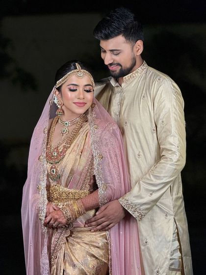 A romantic portrait of the bride and groom. The soft lighting creates a beautiful, intimate mood, and the makeup looks flawless.